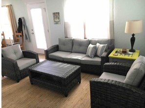 Relax in this inviting living room with a sofa, armchairs, and a coffee table.