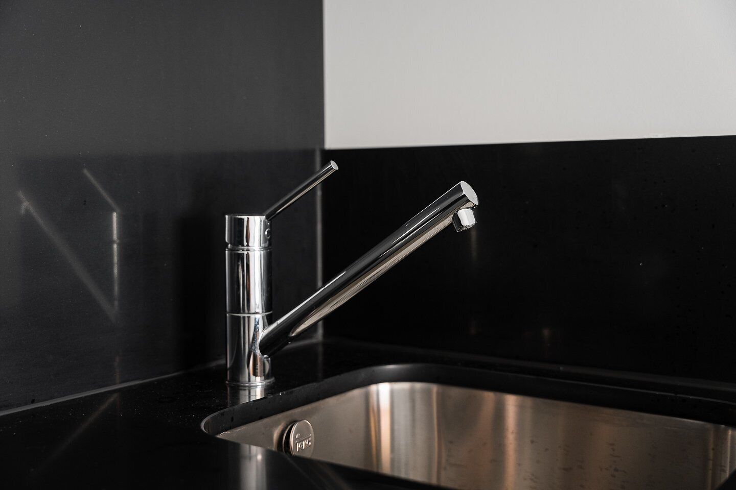 A modern kitchen sink with a sleek chrome faucet and a single-handle design.