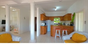Relax in the living area with a wicker sofa and chair, and enjoy the view from the kitchen window.