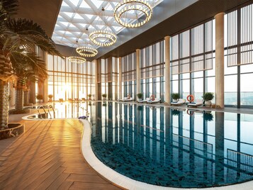 Indoor pool, outdoor pool, pool umbrellas, pool loungers