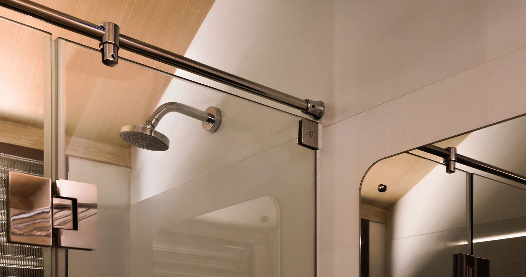 A modern shower with a glass enclosure and a metal handle.
