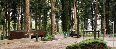 A forested area with a cabin labeled 'Bobocabin' and a jeep parked in front.