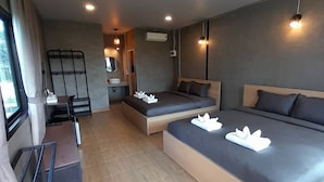 A modern hotel room with a large bed, a smaller bed, a desk, and a seating area. - Thungtheiyngvalley Khaoyai (Pak Chong)