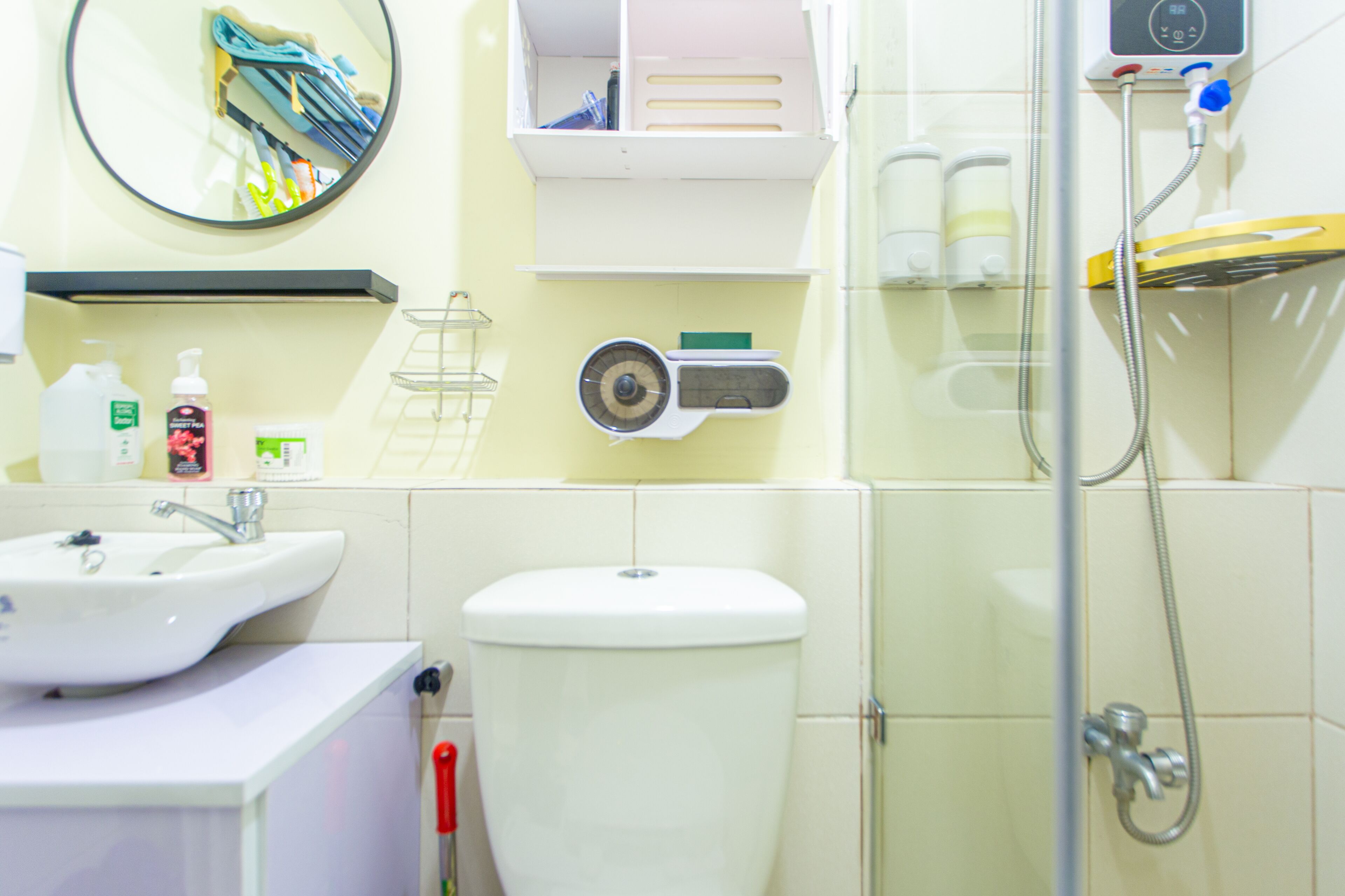 A bathroom with a sink, toilet, and shower.