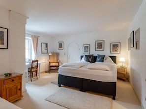 Cozy retreat with a large bed, bedside tables, and a desk area.