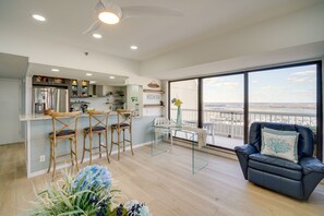 Relax in a spacious living area with a modern kitchen and balcony offering a scenic view.