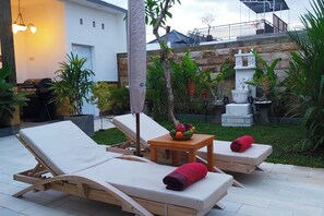Relax in a serene outdoor lounge with comfortable seating and a tranquil atmosphere.