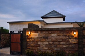 Stylish entrance to a contemporary building with a flat roof and a pitched roof on the upper section.