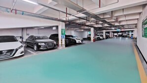 Een meerlaagse parkeergarage met verschillende auto's op de aangegeven plaatsen.