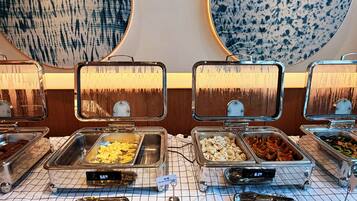 A buffet with various food items, including scrambled eggs and sausage, with temperature displays.