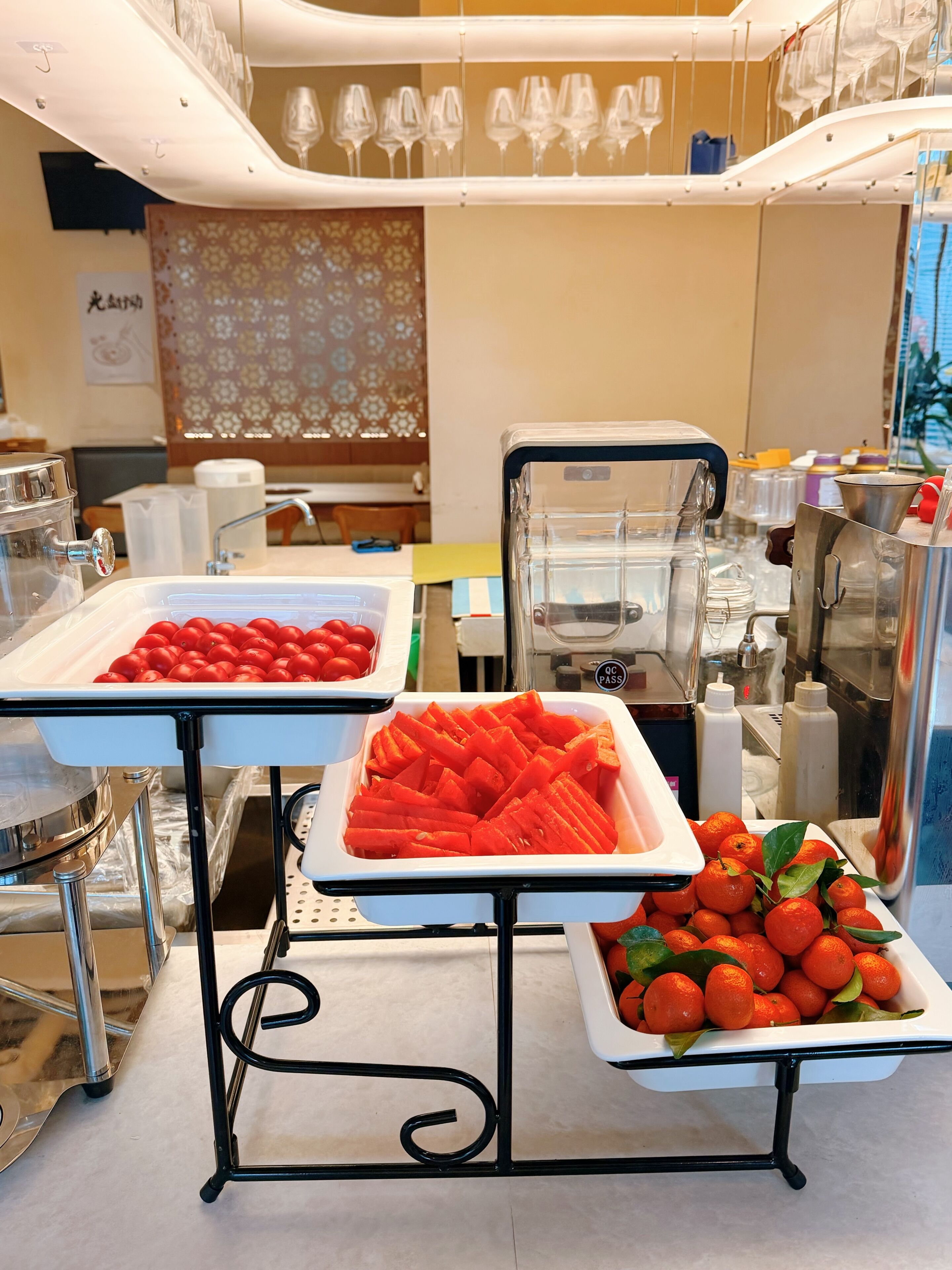 A buffet setup with various food items and kitchen equipment.