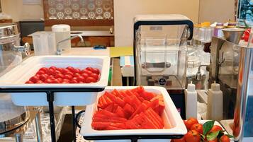 A buffet setup with various food items and kitchen equipment.