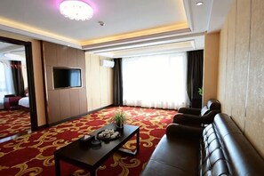 A hotel room with a red carpet, a sofa, a TV mounted on the wall, and a window with curtains. - Fangzheng Golden Lake Hotel (High-speed Railway Station) (Fangzheng)