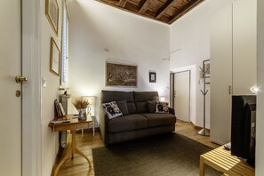 A cozy living room with a sofa, a coffee table, and a TV. - Minerva 5 - FromHometoRome (Roma)