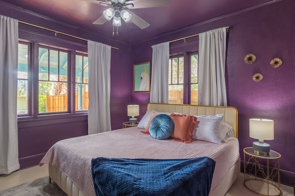 Master bedroom with plush King Bed, TV and desk