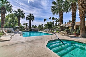 A swimming pool surrounded by palm trees and lounge chairs. - Lake, Mountain & Golf Views: Palm Valley Retreat (Palm Desert)