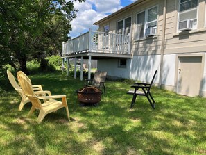 Relax on the covered patio with comfortable seating and enjoy the serene surroundings.