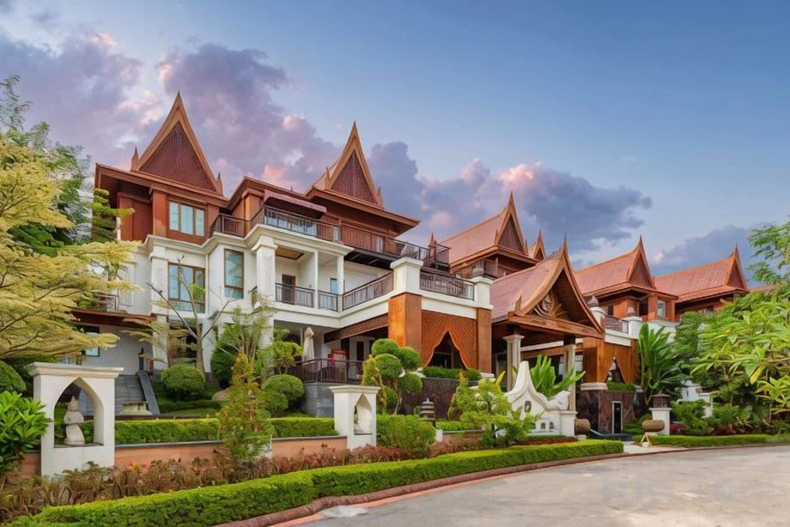A large, multi-story building with a traditional architectural style, featuring multiple balconies and a well-maintained garden.