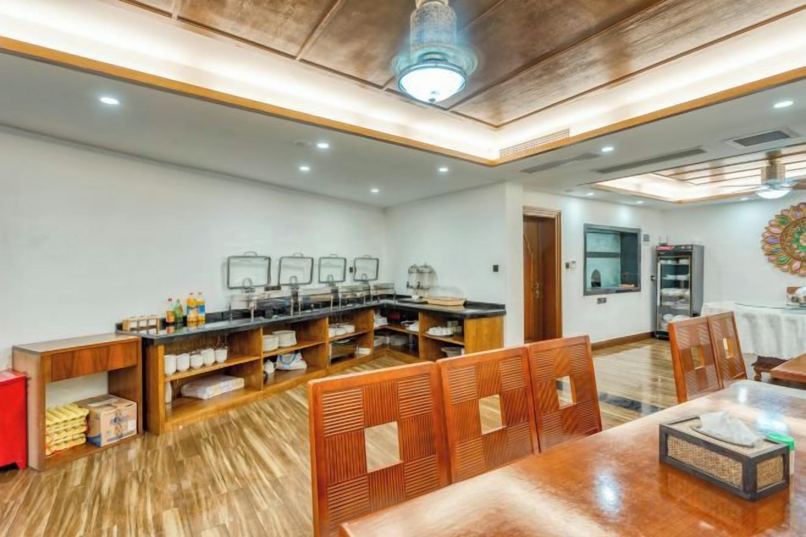 A breakfast area with a long counter, multiple sinks, and a wooden dining table with chairs.