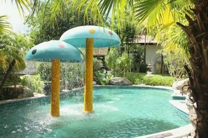 A pool with two water features, surrounded by greenery. - Laiman Resort Hotel (Menghai)