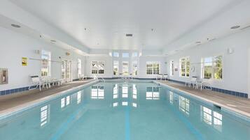 Swimmers can enjoy a refreshing dip in the large indoor pool surrounded by lounge chairs and sunbeds.