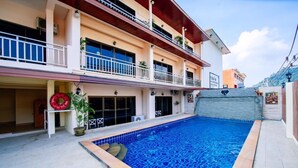 A two-story building with a swimming pool, balconies, and a tiled floor. - Wanna Marine (Patong)