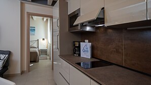 A modern kitchen with a built-in oven, a coffee machine, and a sign for a 'Re Corda Information Book'.