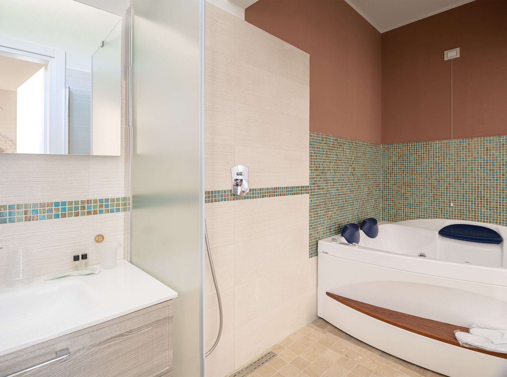 A bathroom with a shower, a bathtub, and a vanity with a mirror.