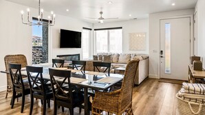 A spacious living room with a dining area, a sofa, and a television. - 1 Chill Casa: Desert Color Lagoon + Beaches (St George)