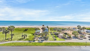 A beachfront property with a parking area, a playground, and a small building. - Updated 3 BR Oceanfront Condo - Drayton House 402 (Myrtle Beach)
