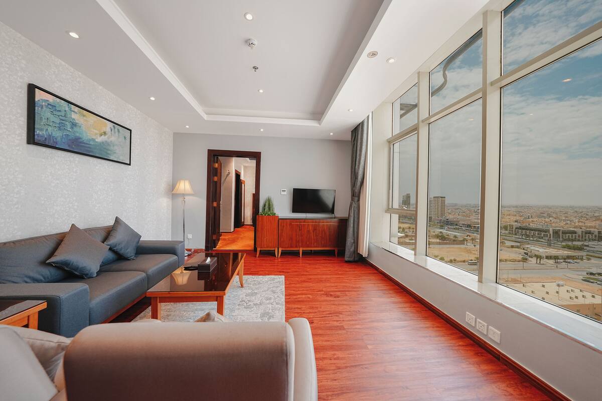 Panoramic Suite | Living area | Flat-screen TV, fireplace, heated floors