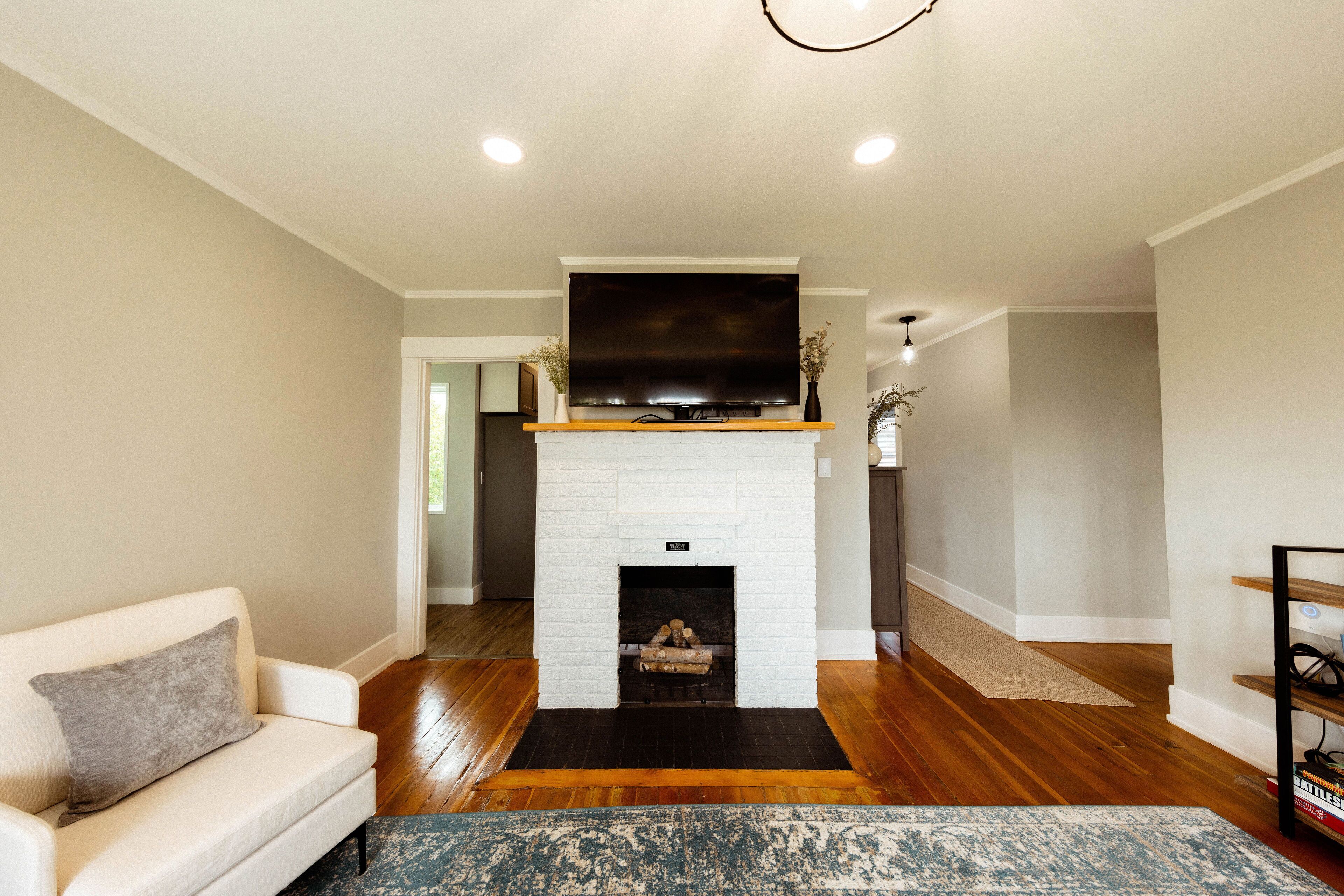 Smart TV, fireplace, books, computer monitors