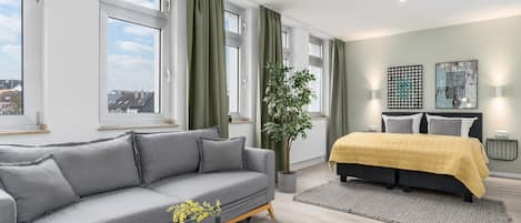 Premium bedding, desk, laptop workspace, blackout drapes