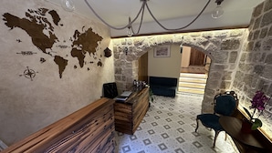 A cozy room with a wooden bench, a desk, and a map on the wall. - Midgard Suites - Medieval Town (Rhodes)