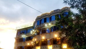 A multi-story building with balconies and a sign that reads "The Mandarin Inn." - The Mandarin Inn (Gilgit)