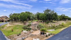 A pathway leading to a hilltop with a sign reading "Hillop Smokehouse". - Lake View @ Hollows Resort: Pools, Pets, Balconies (Jonestown)