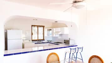 Fridge, microwave, cookware/dishes/utensils, dining tables