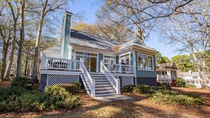 A two-story house with a front porch, a staircase, and a small deck. - Pet Friendly in Great Waters, Docks, Tennis, Pool (Eatonton)
