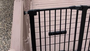 A wooden deck with a metal gate, a white fence, and a blue pool in the background. - POOL, 5 min walk to Jenks, 4 Bedroom, 4 car parking, beach badges, Fence, Pets (Point Pleasant Beach)