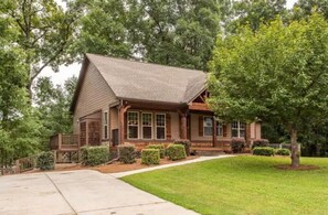Traditional home with a front porch and well-manicured lawn.