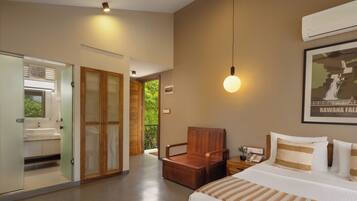 A modern hotel room with a bed, bedside table, and a view of the outdoors.