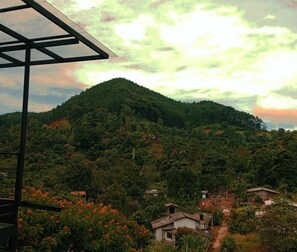 A mountainous landscape with scattered houses and a clear sky.