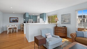 A spacious living area with a dining table, a sofa, and a chair. - Spacious Family Beach Getaway | Scenic Bay Views, AC and Parking! (San Diego)