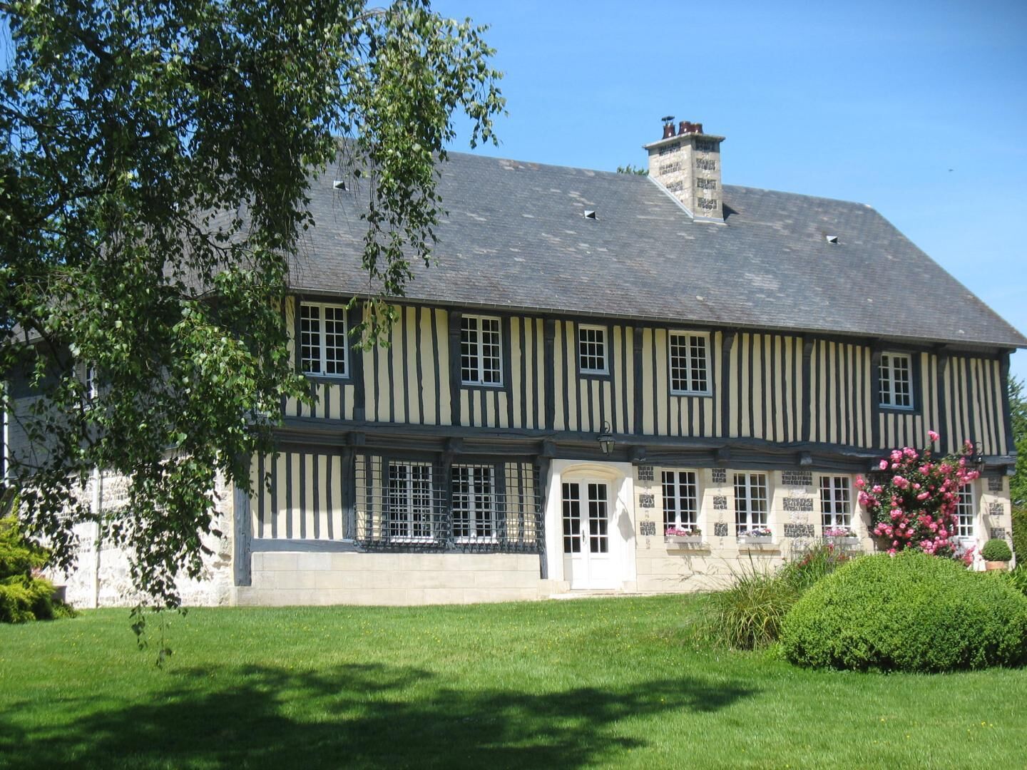 A two-story building with a symmetrical facade, featuring evenly spaced windows and a central entrance.