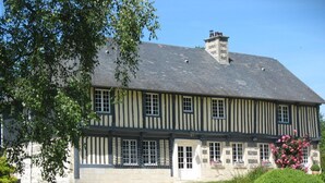A two-story building with a symmetrical facade, featuring evenly spaced windows and a central entrance.