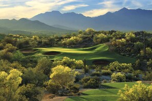 A golf course with a view of mountains in the background.