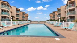 A swimming pool with lounge chairs and a sign indicating shallow water and no diving allowed. - Panoramic oceanfront views, ground floor luxury renovation next to Ocean Annie’s (Myrtle Beach)