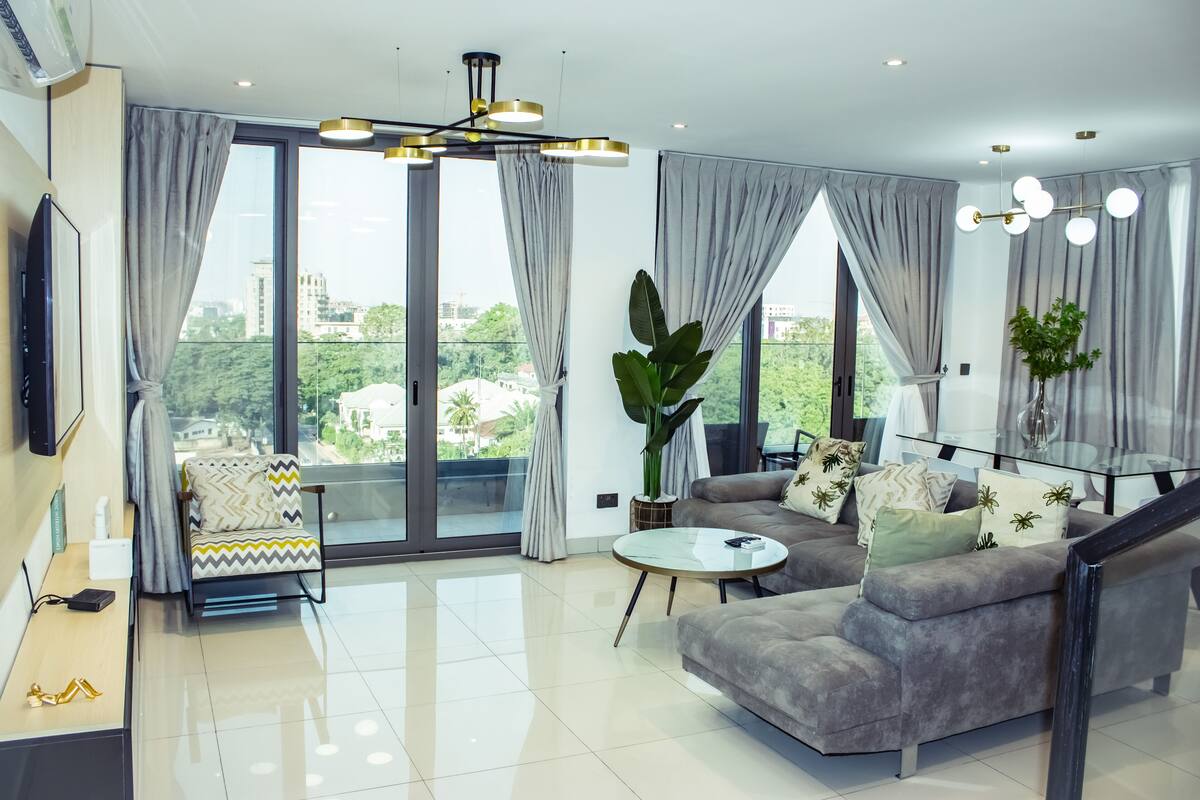 A modern living room with a sofa, a coffee table, and a TV.
