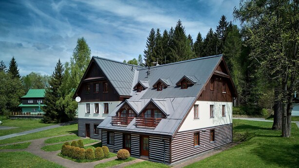 A log cabin with a sloped roof, multiple windows, and a well-maintained lawn. - Harrachov 141 by Interhome (Harrachov)