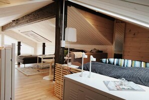 Cozy retreat with a single bed, bedside table, and seating area.